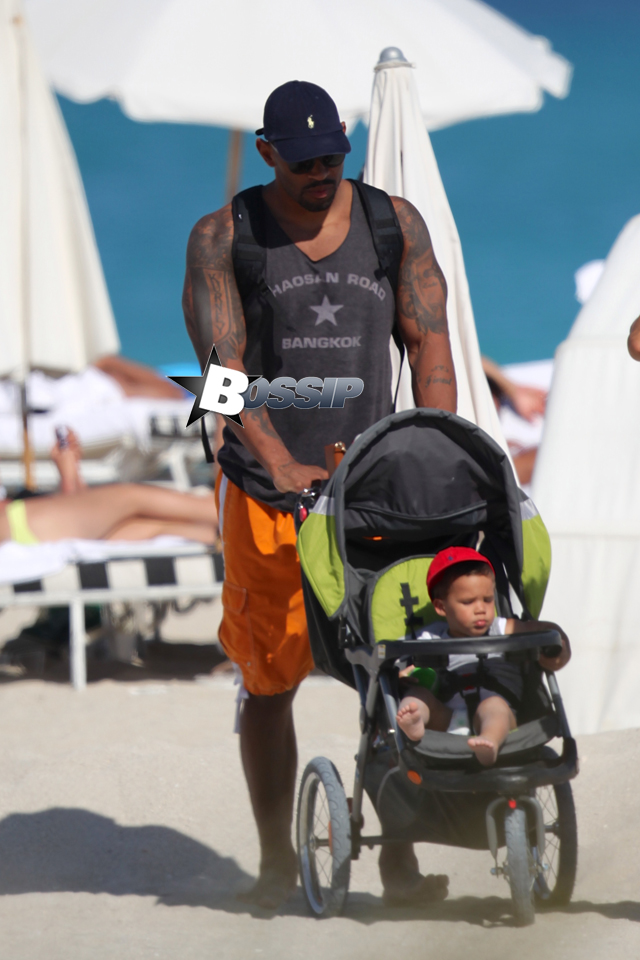 Chicago Bear's Julius Peppers, 33, spends a day at the beach with his family in Miami Beach, FL. Julius was seen pushing his son a stroller on the way back to his hotel.