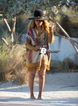 Erykah Badu takes a stroll in a unique looking outfit during a vacation in Miami. The 42-year-old music legend wore an African themed ensemble with a large African tribal necklace over her knitted cardigan and Henna tattoos all over her body. Her large hat had a rattle snake skin around it.