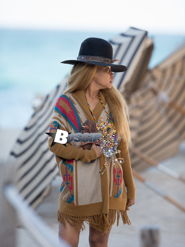 Erykah Badu takes a stroll in a unique looking outfit during a vacation in Miami. The 42-year-old music legend wore an African themed ensemble with a large African tribal necklace over her knitted cardigan and Henna tattoos all over her body. Her large hat had a rattle snake skin around it.