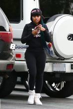 Blac Chyna flashes the peace sign on her way inside a Ralph's grocery store in Calabasas. The former King of Diamonds dancer showed off her extreme assets in a pair of black leggings, black Adidas hooded sweatshirt and a pink and black Last Kings ball cap.