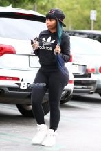 Blac Chyna flashes the peace sign on her way inside a Ralph's grocery store in Calabasas. The former King of Diamonds dancer showed off her extreme assets in a pair of black leggings, black Adidas hooded sweatshirt and a pink and black Last Kings ball cap.