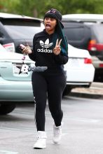 Blac Chyna flashes the peace sign on her way inside a Ralph's grocery store in Calabasas. The former King of Diamonds dancer showed off her extreme assets in a pair of black leggings, black Adidas hooded sweatshirt and a pink and black Last Kings ball cap.