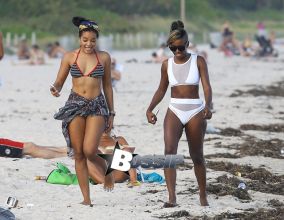Hip-hop mogul offspring Angela Simmons chats up a friend while taking a stroll on the beach in Miami, Florida on December 6, 2013.