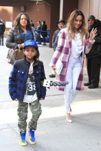 LaLa Anthony takes her son Kiyan to watch Carmelo Anthony and his New York Knicks take on the Brooklyn Nets at Madison Square Garden. The basketball wife showed her support in a plaid Knicks colored wool coat with a white clutch and heels.