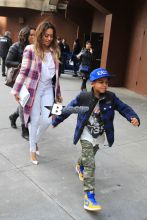 LaLa Anthony takes her son Kiyan to watch Carmelo Anthony and his New York Knicks take on the Brooklyn Nets at Madison Square Garden. The basketball wife showed her support in a plaid Knicks colored wool coat with a white clutch and heels.
