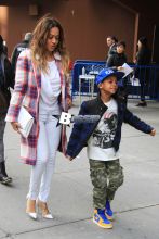 LaLa Anthony takes her son Kiyan to watch Carmelo Anthony and his New York Knicks take on the Brooklyn Nets at Madison Square Garden. The basketball wife showed her support in a plaid Knicks colored wool coat with a white clutch and heels.