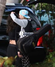 Actress Michelle Rodriguez and supermodel Cara Delevingne kiss before hopping in a car on their way to a music festival in Miami, FL. The rumored couple are on holiday in Florida after spending a week in Mexico.