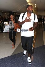 Gilbert Arenas and his significant other Laura Govan pose for pictures as they make their way through the terminal at LAX. The three-time NBA All-Star has done very well for himself after the end of his professional career. Arenas pulled in nearly $25 millions dollars last year while not actually playing in the NBA!