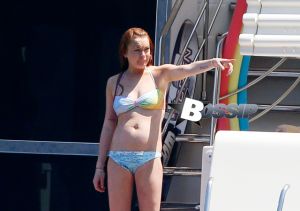 Former child star turned party girl Lindsay Lohan teaches her little sister the ropes as the two soak up the sun and relax while on board a luxury yacht in Capri.