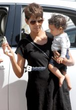 Halle Berry steps out with her 9 month old son, Maceo this afternoon for some mother-son time. The actress carried her little boy in one arm while holding a giraffe toy in hand. It looks like Maceo wanted his favorite toy had his eyes on it the whole time. Halle was dressed for the warm weather wearing a black high-low dress, which revealed what may possibly a baby bump. Could Halle be pregnant with her third child?