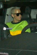 Amber Rose and Wiz Khalifa exit out the side door of the Roxy after wiz's show. Amber is looking cute in green, yellow and red sweater with black pants.