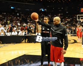 Rihanna watches her ex boyfriend Chris Brown as he plays a charity basketball while she sits courtside with Cara Delevingne. The girls were talking as Chris played ball and Chris did not look over at her but Rihanna looked at him many times as he went up and down the court. Later she was seen smiling as she posed with many children and even hugged as they came up to greet her
