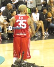 Rihanna watches her ex boyfriend Chris Brown as he plays a charity basketball while she sits courtside with Cara Delevingne. The girls were talking as Chris played ball and Chris did not look over at her but Rihanna looked at him many times as he went up and down the court. Later she was seen smiling as she posed with many children and even hugged as they came up to greet her