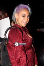 Raven-Symoné is looking radical in red with her partially shaved head with purple highlights. Raven shows of a beautiful smile as she poses for a photo, leaving the Roxy after seeing the Wiz Khalifa show.