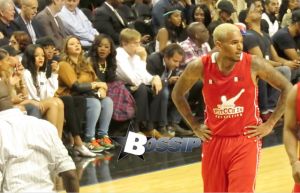 Rihanna watches her ex boyfriend Chris Brown as he plays a charity basketball while she sits courtside with Cara Delevingne. The girls were talking as Chris played ball and Chris did not look over at her but Rihanna looked at him many times as he went up and down the court. Later she was seen smiling as she posed with many children and even hugged as they came up to greet her