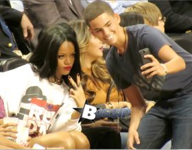 Rihanna watches her ex boyfriend Chris Brown as he plays a charity basketball while she sits courtside with Cara Delevingne. The girls were talking as Chris played ball and Chris did not look over at her but Rihanna looked at him many times as he went up and down the court. Later she was seen smiling as she posed with many children and even hugged as they came up to greet her