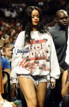 Rihanna watches her ex boyfriend Chris Brown as he plays a charity basketball while she sits courtside with Cara Delevingne. The girls were talking as Chris played ball and Chris did not look over at her but Rihanna looked at him many times as he went up and down the court. Later she was seen smiling as she posed with many children and even hugged as they came up to greet her