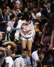 Rihanna watches her ex boyfriend Chris Brown as he plays a charity basketball while she sits courtside with Cara Delevingne. The girls were talking as Chris played ball and Chris did not look over at her but Rihanna looked at him many times as he went up and down the court. Later she was seen smiling as she posed with many children and even hugged as they came up to greet her