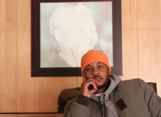 Carmelo Anthony sits at Nelson Mandela's desk