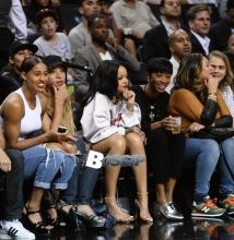 Rihanna watches her ex boyfriend Chris Brown as he plays a charity basketball while she sits courtside with Cara Delevingne. The girls were talking as Chris played ball and Chris did not look over at her but Rihanna looked at him many times as he went up and down the court. Later she was seen smiling as she posed with many children and even hugged as they came up to greet her