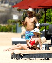 Newlyweds Ashlee Simpson and Evan Ross take in the beauty of Bali and hit the beach to catch some sun. Ashlee wore a one piece red bathing suit and large sun hat to match husband Evan Ross. At one point, Evan took some time to take a cell phone photo of Ashlee sunbathing with the beautiful backdrop of the ocean behind her as a backdrop.