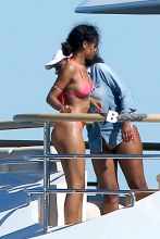 Despite her unflattering bathing suit cover, Rihanna relaxes in a hot pink bikini while vacationing in Saint-Tropez on a yacht. The