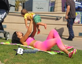 Brazilan model Suelyn Medeiros shows off her curves with baby son in Los Angeles wearing the colorful 'Bombshells' apparel line in on a sunny day in Santa Monica, California. The model who is best known for her backside, was enjoying a workout and then took time to have playtime with her 11 month old baby son who has his own Instagram page, IMBABYJJ, Joseph Jr. with nearly 9000k followers himself, as he stole the show from his mommy as they played together for all to see in the park.