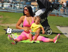 Brazilan model Suelyn Medeiros shows off her curves with baby son in Los Angeles wearing the colorful 'Bombshells' apparel line in on a sunny day in Santa Monica, California. The model who is best known for her backside, was enjoying a workout and then took time to have playtime with her 11 month old baby son who has his own Instagram page, IMBABYJJ, Joseph Jr. with nearly 9000k followers himself, as he stole the show from his mommy as they played together for all to see in the park.