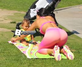 Brazilan model Suelyn Medeiros shows off her curves with baby son in Los Angeles wearing the colorful 'Bombshells' apparel line in on a sunny day in Santa Monica, California. The model who is best known for her backside, was enjoying a workout and then took time to have playtime with her 11 month old baby son who has his own Instagram page, IMBABYJJ, Joseph Jr. with nearly 9000k followers himself, as he stole the show from his mommy as they played together for all to see in the park.