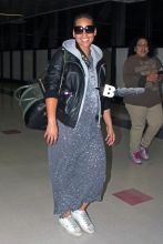 Los Angeles, CA - Alicia Keys smiles wide as she makes her way through LAX Airport with her son Egypt following a late flight into Los Angeles. Alicia, who is pregnant with her second child, is currently a mentor to Pharrell Williams’ team on ‘The Voice’. The braided R&B singer wore a black leather jacket over a splatter painted grey dress, white sneakers and a pair of sunglasses.