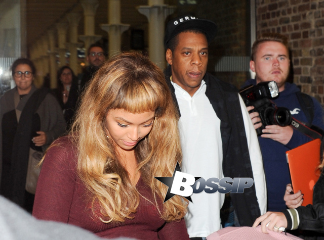 Beyonce and Jay Z slowing walk with their daughter Blue through the crowd after arriving in London. The famous family took the Eurostar after spending time in Paris. Beyonce dressed in a full maroon outfit matching her clutch, and showed off her new blunt bangs.