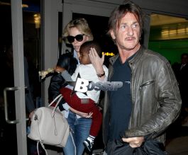 Charlize Theron and Sean Penn arrive at LAX airport with Charlize's son Jackson Theron, where Charlize covers her son face as they head to the car.