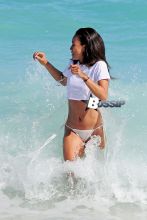 Karrueche Tran forgets about Chris Brown with a fun and relaxing trip to the beach in Miami with a couple of friends. The brunette beauty showed off her amazing beach body wearing a white bikini with a white crop top.