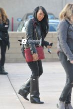 Khloe Kardashian was dressed to kill on Monday when she showed up at Fusion Luxury Motors in Chatsworth with her best friend Malika Haqq to film a segment for 'Keeping Up with the Kardashians.' The pair arrived in Khloe's Rolls Royce and checked out a salmon-pink vintage Thunderbird convertible. Khloe showed off her famous curves in a skin-tight leather dress topped with a tied-up flannel and sky-high Louboutin pumps.