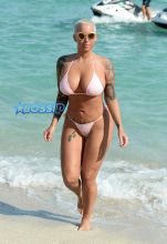 Amber Rose leaves little to the imagination as she wears a pink thong bikini on the beach in Miami, Florida. Rose can be seen having good time on a jet ski in Miami.