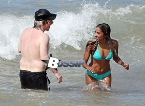 TV personality Bill Maher and Anjulie Persaud enjoying a day on the beach in Maui, Hawaii on January 4, 2015. Bill and Anjulie laughed and joked as they played around in the waves. Anjulie won a Juno Award in 2013 for Best Dance Recording Of The Year for her song 'You And I'. FameFlynet