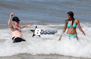 TV personality Bill Maher and Anjulie Persaud enjoying a day on the beach in Maui, Hawaii on January 4, 2015. Bill and Anjulie laughed and joked as they played around in the waves. Anjulie won a Juno Award in 2013 for Best Dance Recording Of The Year for her song 'You And I'. FameFlynet