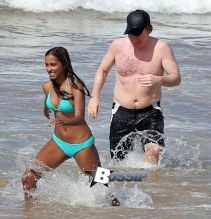 TV personality Bill Maher and Anjulie Persaud enjoying a day on the beach in Maui, Hawaii on January 4, 2015. Bill and Anjulie laughed and joked as they played around in the waves. Anjulie won a Juno Award in 2013 for Best Dance Recording Of The Year for her song 'You And I'. FameFlynet