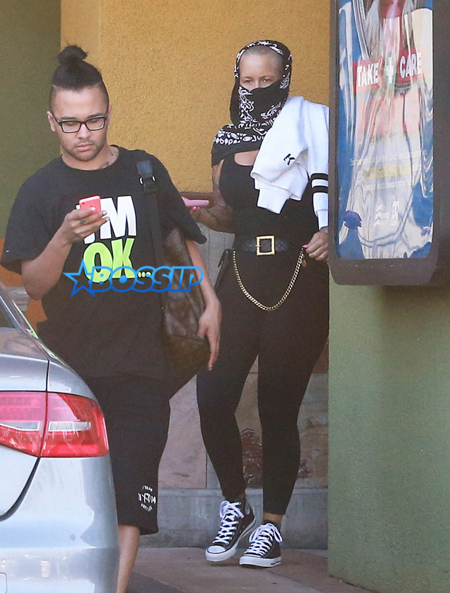 Model Amber Rose hides her face with a black scarf while leaving a nail salon in Studio City, California