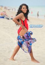 **USA ONLY** Miami, FL - Rapper Rev Run's daughter Angela, known for their family reality show 'Run's House,' is clearly all grown up! The 27-year-old curvy babe was spotted having fun with her girlfriends on a beach in Miami on Monday, wearing a 'Baywatch'-style red Wildfox one piece with the words "This Bod's For You" written across the front. The girls laughed and played in the sand, practicing their yoga backbends while snapping photos.