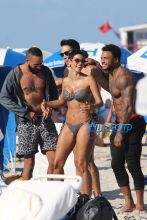 Nicole Murphy shows off her bikini body as she spends the day at the beach in Miami with David McIntosh and friends.