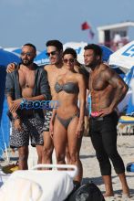 Nicole Murphy shows off her bikini body as she spends the day at the beach in Miami with David McIntosh and friends.