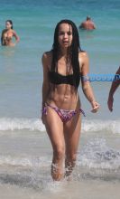 Zoe Kravitz showed off her impeccable bikini body while frolicking in the ocean in Miami Beach. She looked stunning in a black bikini top and graphic print string bikini bottoms.