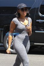 Shoe designer Angela Simmons feeds her meter with a friend before heading into a nail salon in skin tight leggings and a matching top, revealing her bootylicious curves.
