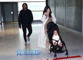 Reality star Kim Kardashian, her husband Kanye West and their daughter North arrive on a flight from Isreal at Roissy Charles-de-Gaulle airport in Paris, France on April 14, 2015. The couple baptized their daughter North at Saint James Cathedral in Jerusalem yesterday.