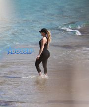 Khloe Kardashian works out on the beach in st. barths