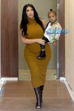 Pregnant Kim Kardashian West mustard dress North silk bomber black boots bun baby bump big butt NYC AKM-GS