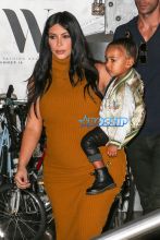 Pregnant Kim Kardashian West mustard dress North silk bomber black boots bun baby bump big butt NYC AKM-GS