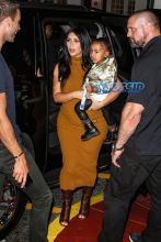 Pregnant Kim Kardashian West mustard dress North silk bomber black boots bun baby bump big butt NYC AKM-GS