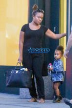 North West NYC ponytail afropuff water bottle nanny black dress Doc Martens denim jean jacket AKM-GSI
